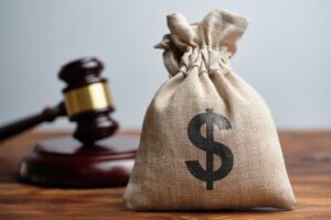 Dollar Bag & Judge's Gavel. Concept of Maximizing Settlement & Compensation