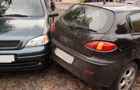 Two cars in a small wreck.