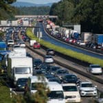 Multiple lanes of bumper to bumper traffic going in opposite directions.