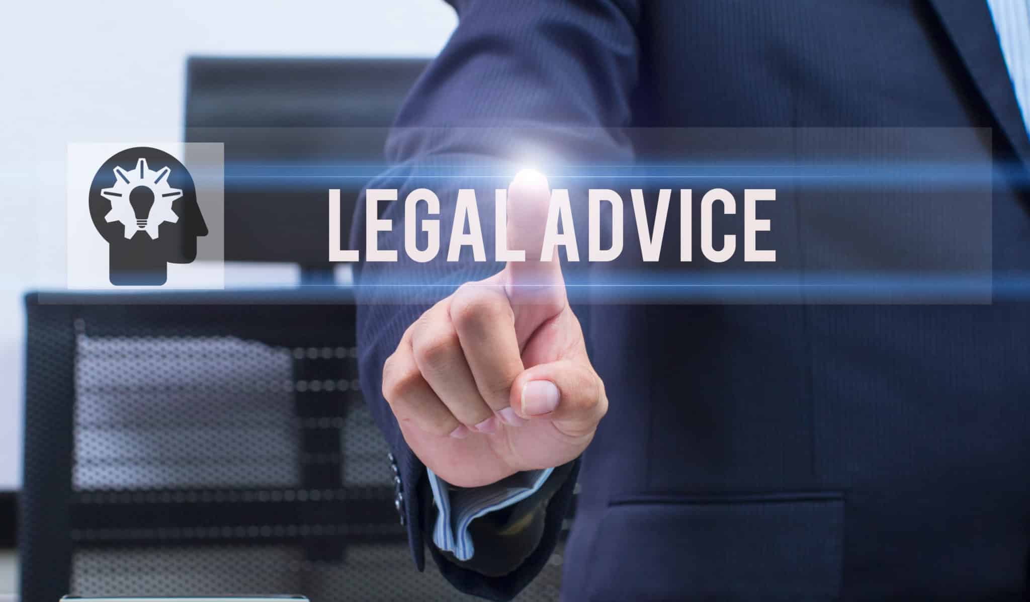 A man in a business suite touching the word legal advice in the foreground.