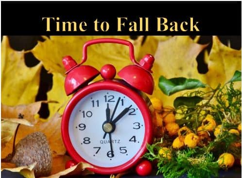 A clock in front of a fall background with the title, "Time to Fall Back."