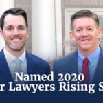 Two proffesional males standing beside each other in front of an office building with the words Named 2020 Super Lawyers Rising Stars.