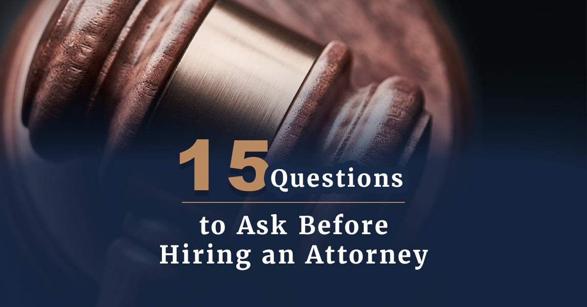 A wooden gavel behind the title 15 questions to ask before hiring an attorney.