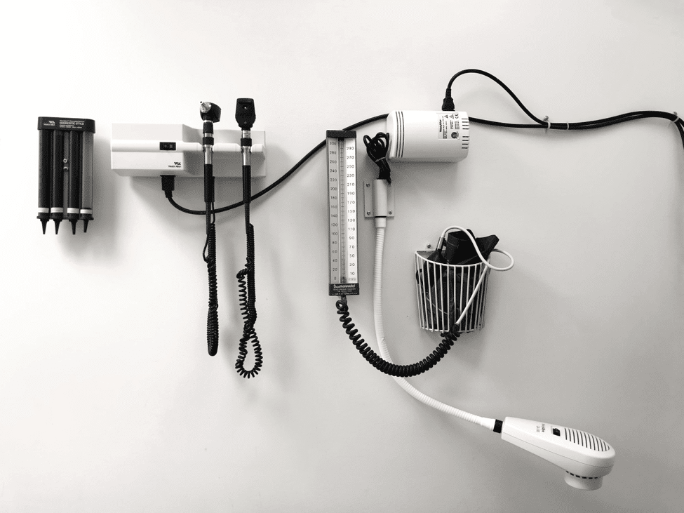 Two stethoscopes and various other medical equipment against a white background.