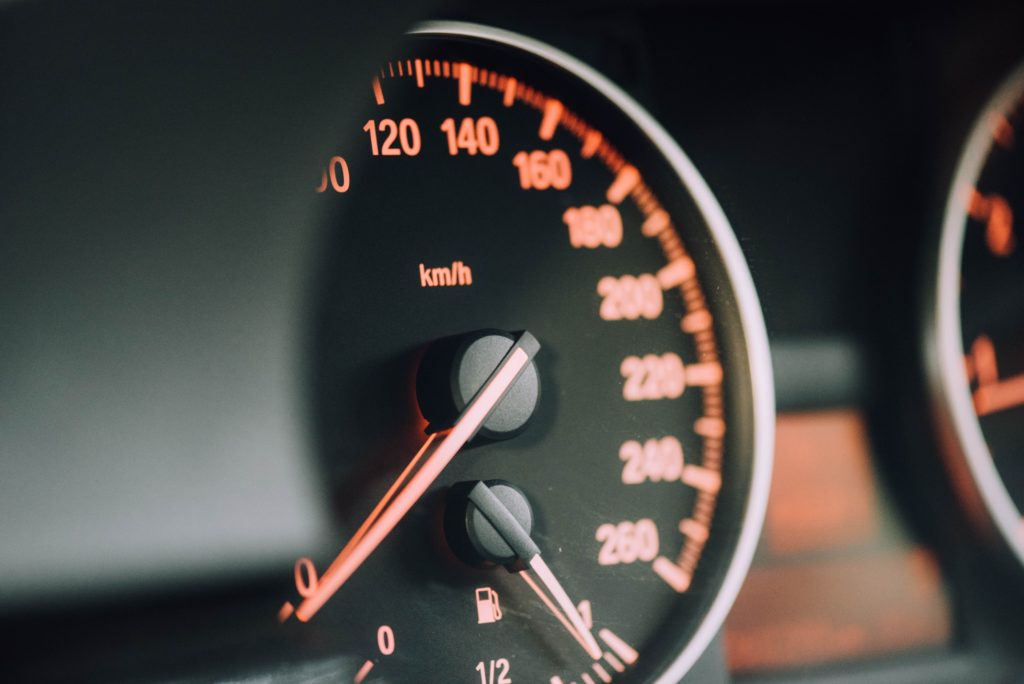 A close up of a car speedometer going zero mph.