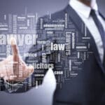 Blurry image of a man in a suit in the background pointing toward a collection of lawyer associated words in the foreground.