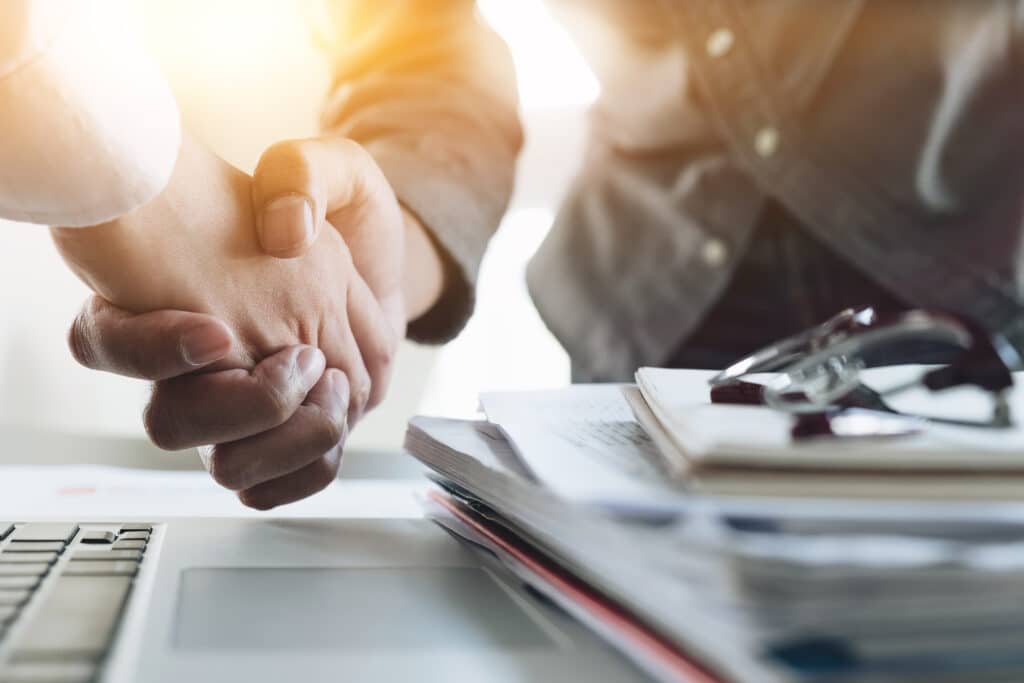 Close up of Business people shaking hands, finishing up meeting.