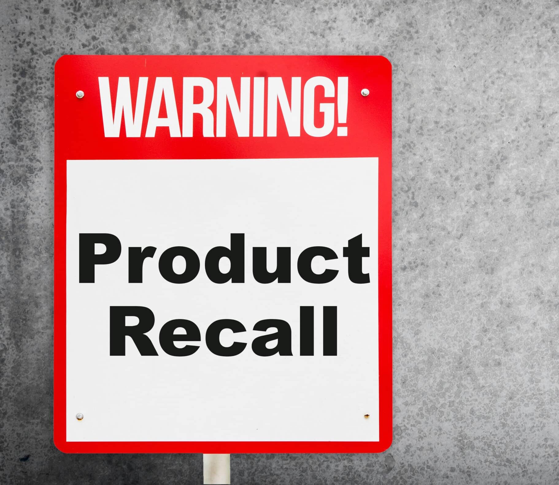 signage with WARNING written in bold white letters and Product Recall written in black letters