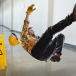 Worker falling on wet floor inside building