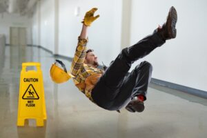 Worker falling on wet floor inside building