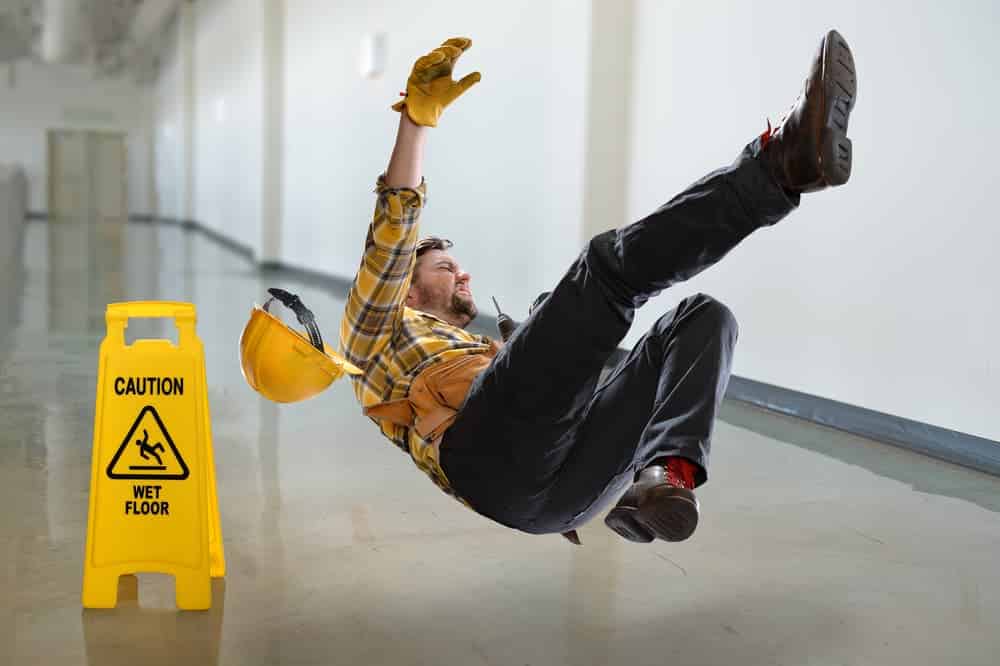Worker falling on wet floor inside building