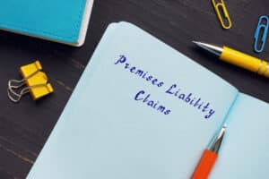 Premises Liability Claims written on page with legal sign, juridical concept of property owner responsibility.