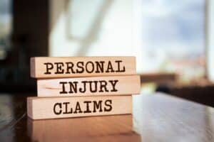 Wooden blocks arranged with words Personal Injury Claims, legal and insurance compensation concept