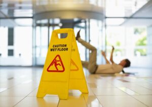 man slipping on wet office floor